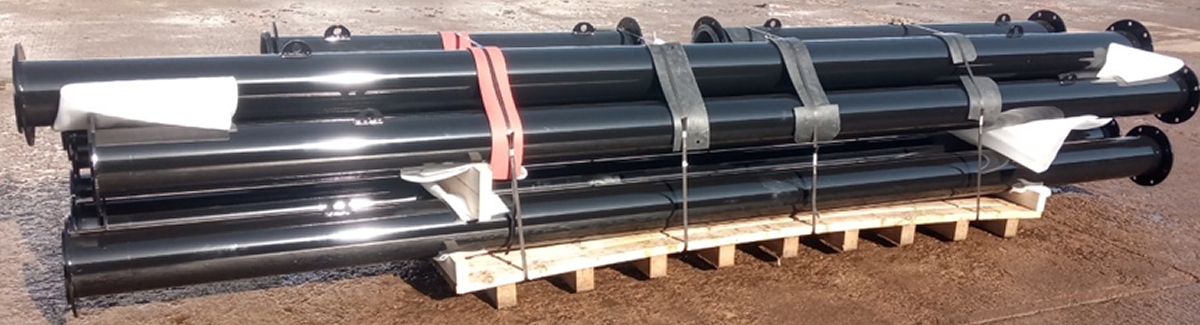 Steel pipe fabrications painted black sitting on a pallet